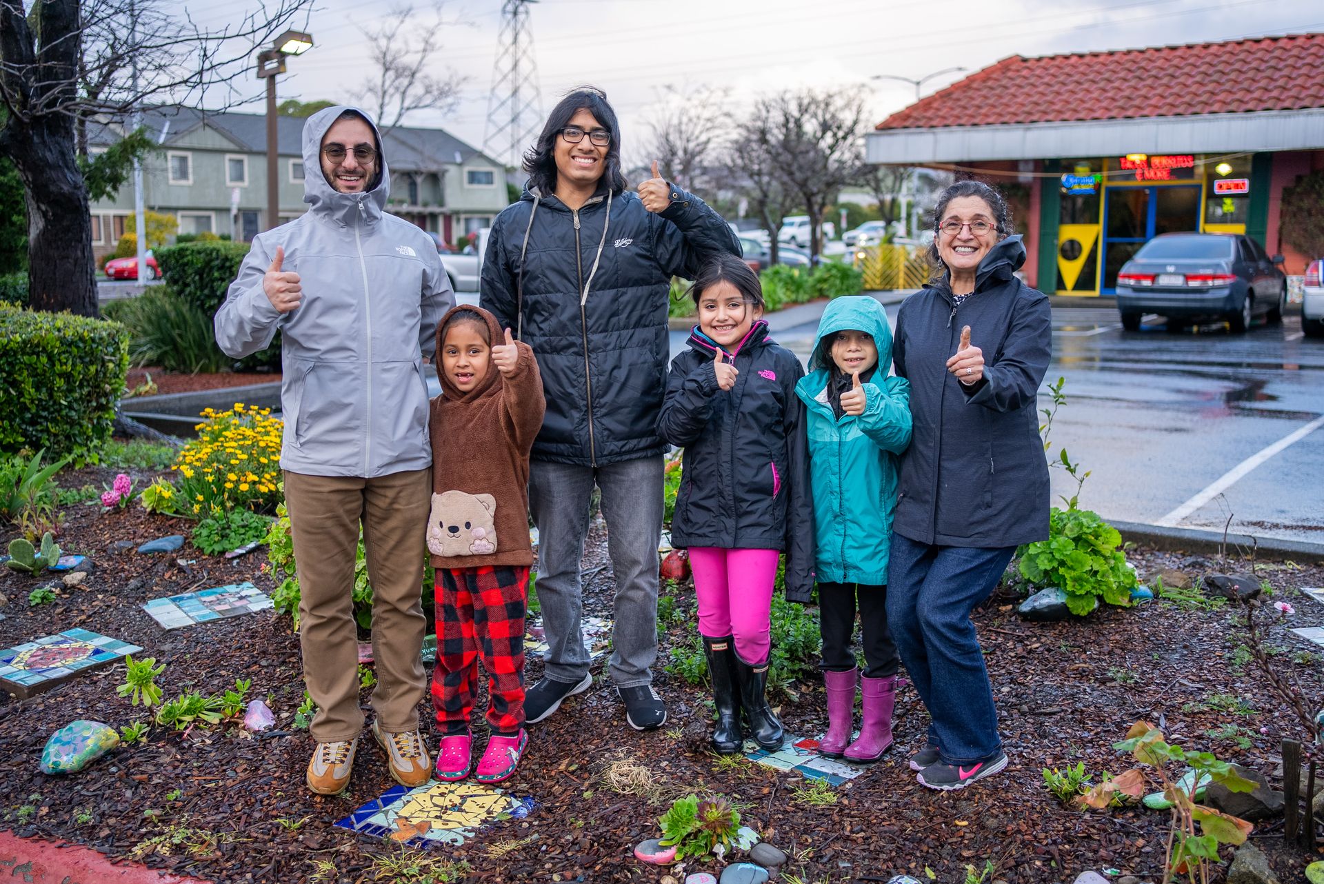 Community members standing in a neighborhood garden