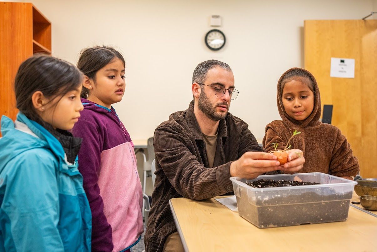 Youth learning about planting and soil together